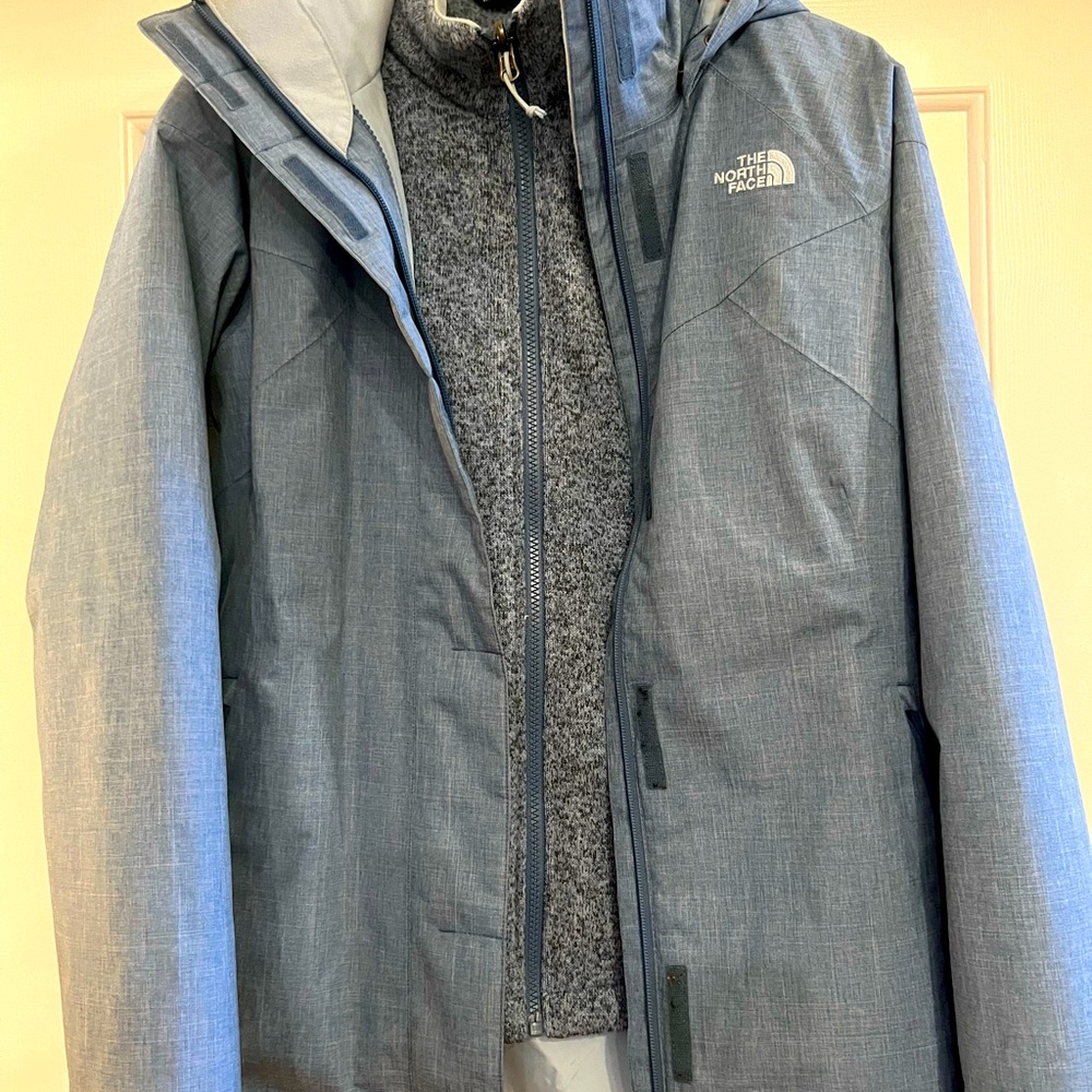 North Face two in one denim blue ski jacket. Orange zipper trim.